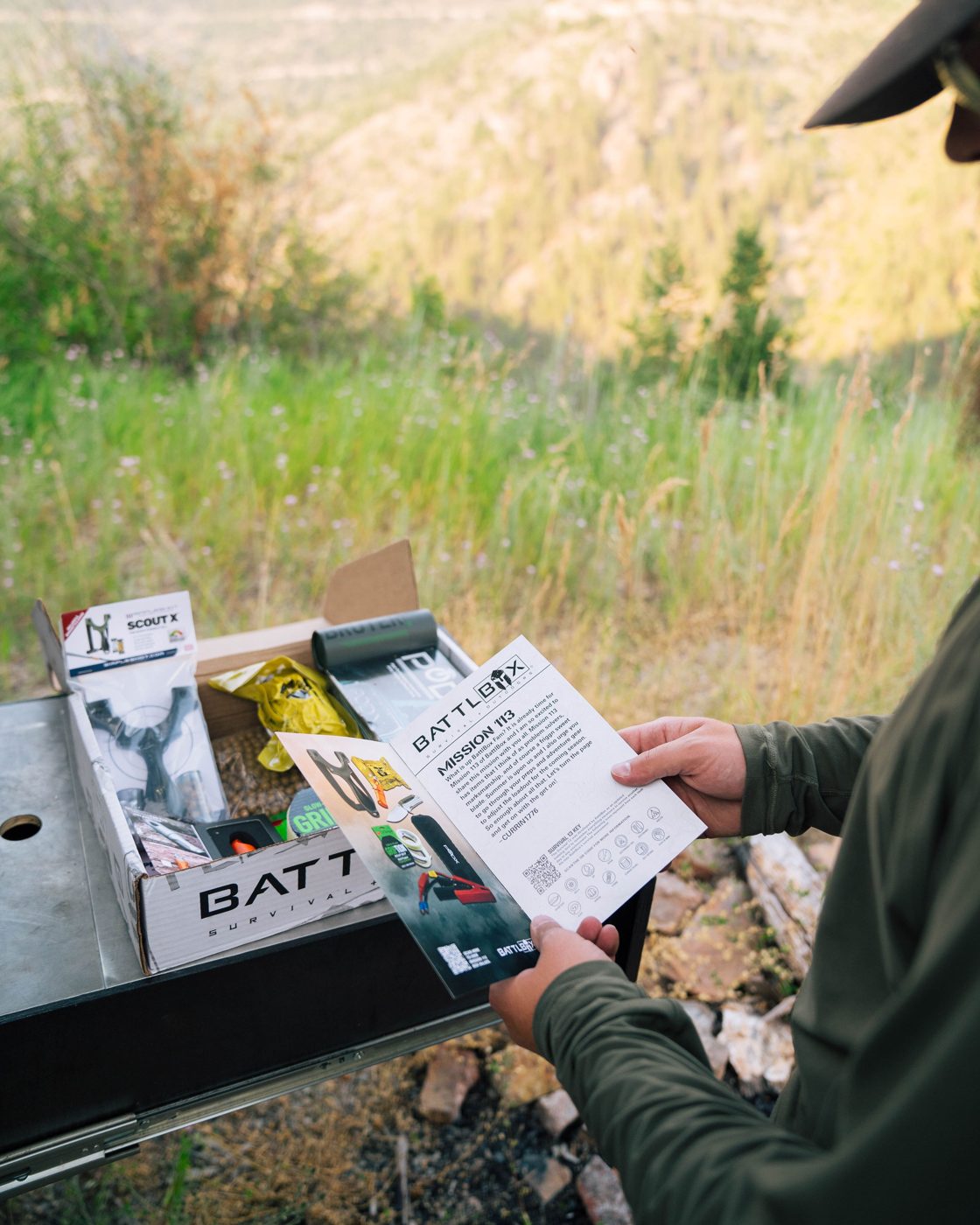 A member reading the mission card next to an open box at camp